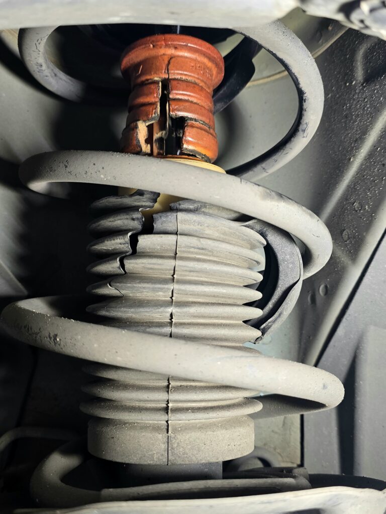 Deteriorated shock absorber rubber component found during used car inspection