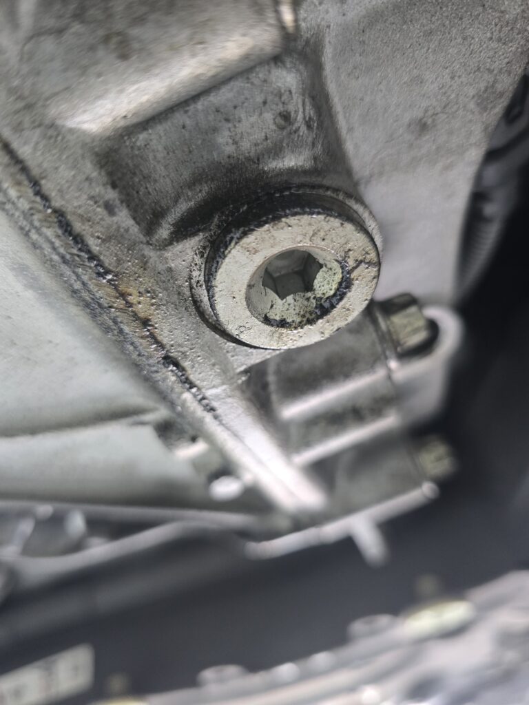Oil staining found during used car undercarriage inspection